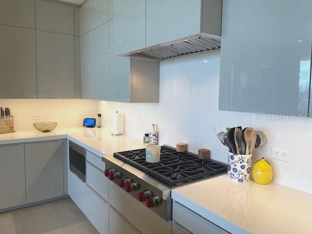 1581 Gulf Of Mexico Drive, Unit 307 Longboat Key, FL 34228 - Photo 12 of 83 a kitchen with a sink stove and cabinets