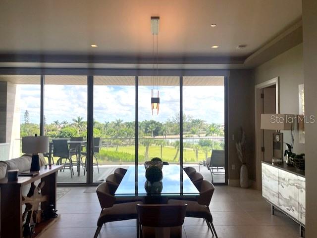 1581 Gulf Of Mexico Drive, Unit 307 Longboat Key, FL 34228 - Photo 14 of 83 a view of a city from a dining room with large windows and a table
