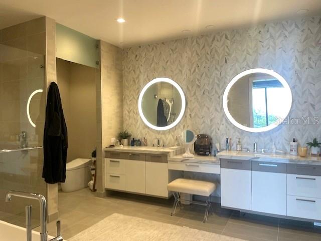 1581 Gulf Of Mexico Drive, Unit 307 Longboat Key, FL 34228 - Photo 28 of 83 a bathroom with a double vanity sink and a mirror