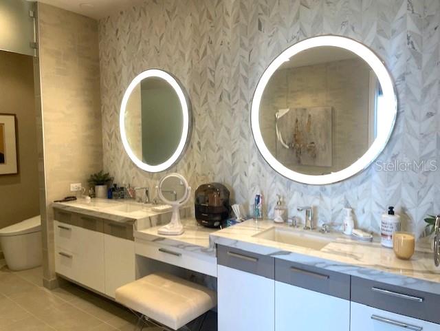 1581 Gulf Of Mexico Drive, Unit 307 Longboat Key, FL 34228 - Photo 30 of 83 a bathroom with a granite countertop double vanity sink and a mirror