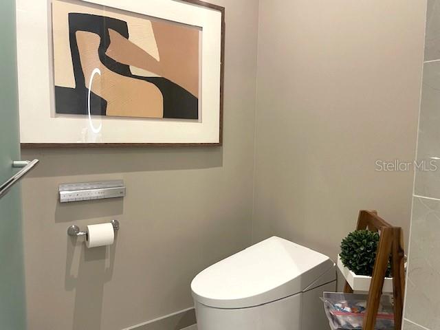 1581 Gulf Of Mexico Drive, Unit 307 Longboat Key, FL 34228 - Photo 31 of 83 a bathroom with a toilet and a sink