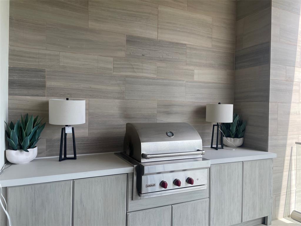 1581 Gulf Of Mexico Drive, Unit 307 Longboat Key, FL 34228 - Photo 36 of 83 a kitchen with a sink cabinets and a potted plant