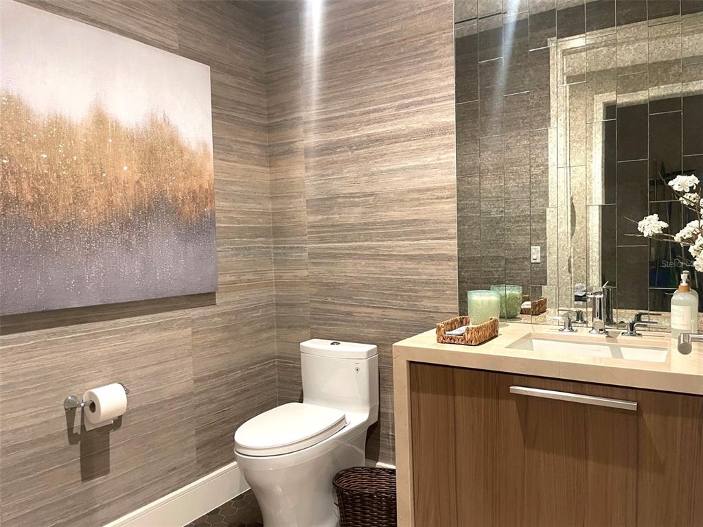 1581 Gulf Of Mexico Drive, Unit 307 Longboat Key, FL 34228 - Photo 40 of 83 a bathroom with a toilet a sink and mirror