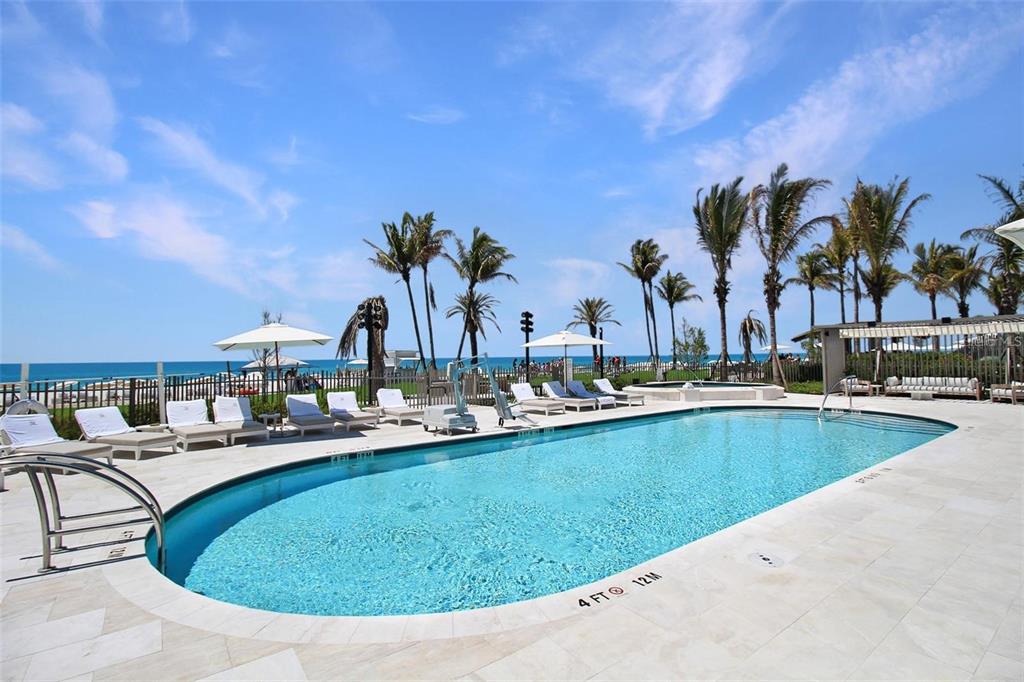 1581 Gulf Of Mexico Drive, Unit 307 Longboat Key, FL 34228 - Photo 50 of 83 a view of a swimming pool with outdoor seating