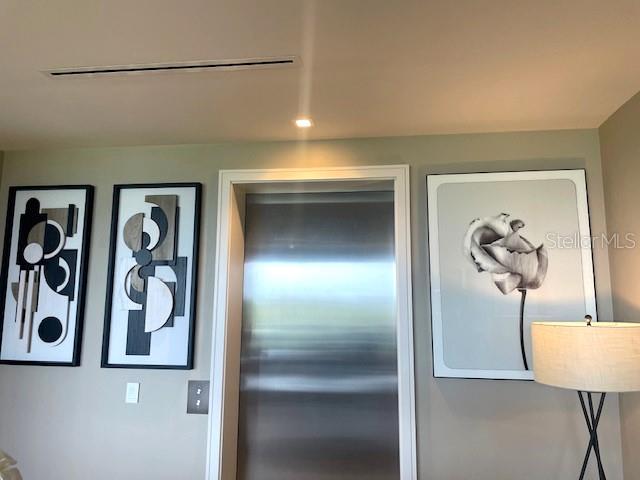 1581 Gulf Of Mexico Drive, Unit 307 Longboat Key, FL 34228 - Photo 5 of 83 a view of a hallway with paintings on the wall