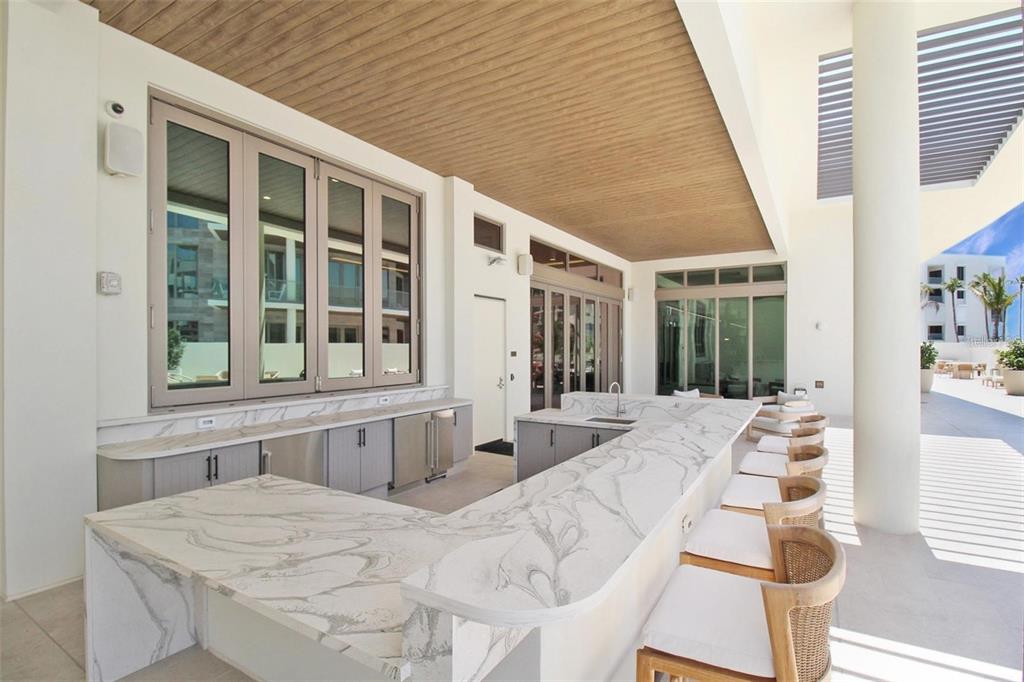1581 Gulf Of Mexico Drive, Unit 307 Longboat Key, FL 34228 - Photo 59 of 83 a large white kitchen with sink and natural light