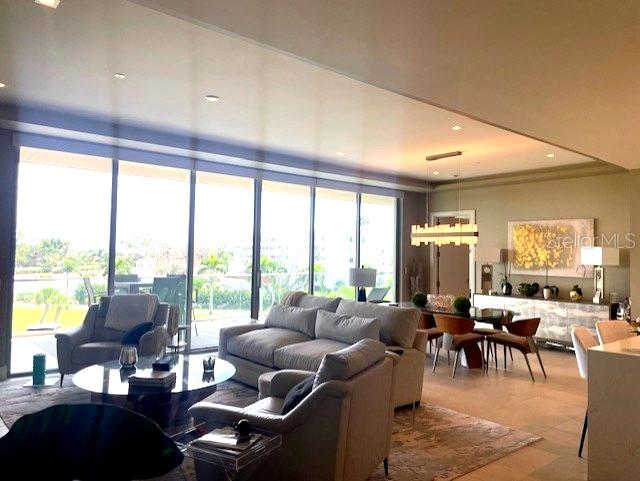 1581 Gulf Of Mexico Drive, Unit 307 Longboat Key, FL 34228 - Photo 6 of 83 a living room with furniture and large windows