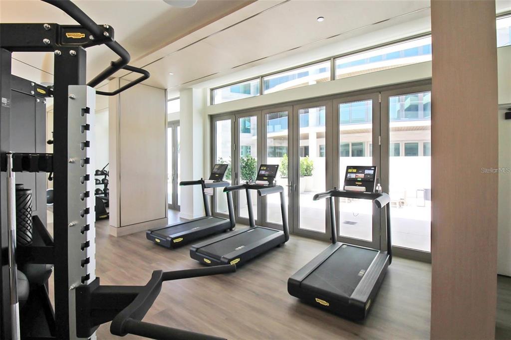 1581 Gulf Of Mexico Drive, Unit 307 Longboat Key, FL 34228 - Photo 61 of 83 a room with gym equipment and a large window