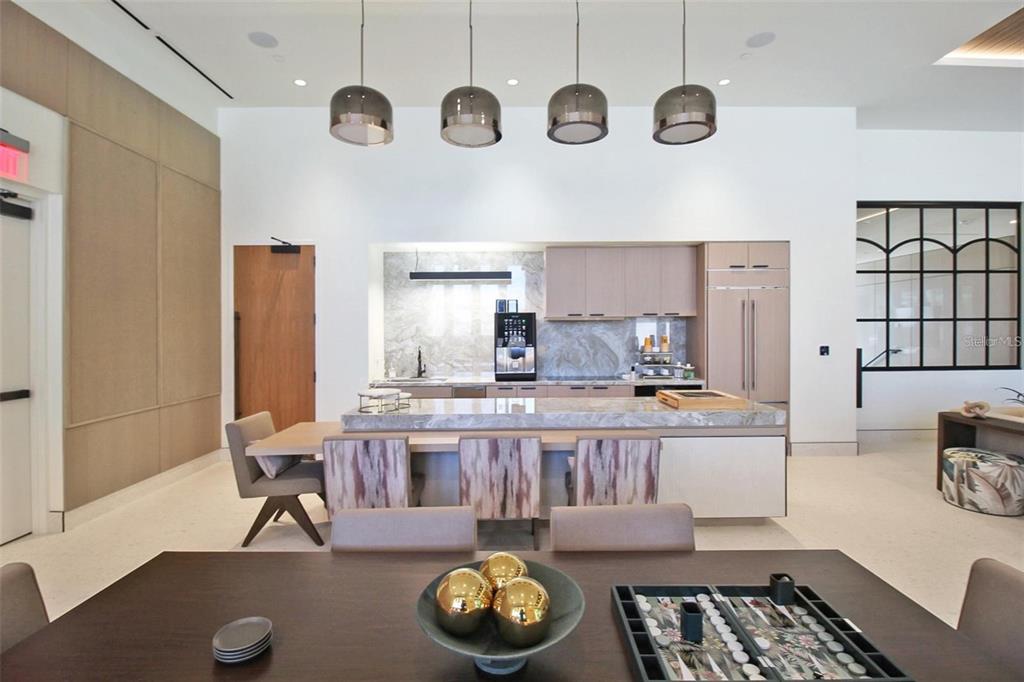 1581 Gulf Of Mexico Drive, Unit 307 Longboat Key, FL 34228 - Photo 64 of 83 a living room with a couch and a table with wooden floor