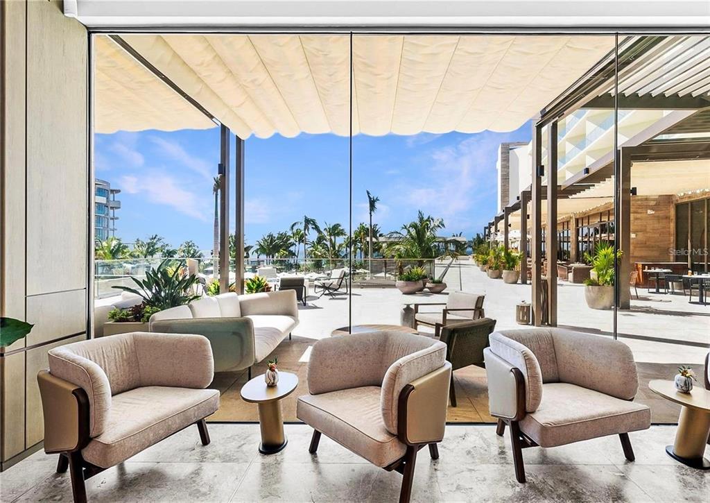 1581 Gulf Of Mexico Drive, Unit 307 Longboat Key, FL 34228 - Photo 73 of 83 a living room with furniture city view and large windows