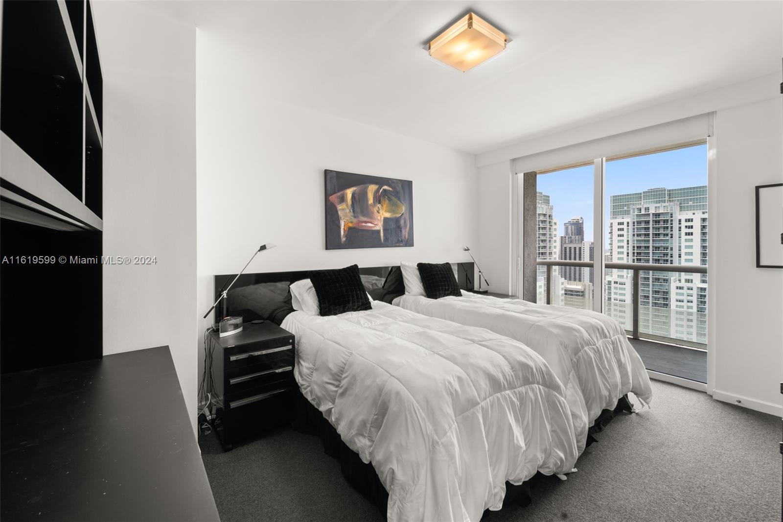 50 Biscayne Boulevard, Unit 4802 Miami, FL 33132 - Photo 21 of 27 a large bed sitting in a bedroom next to a window