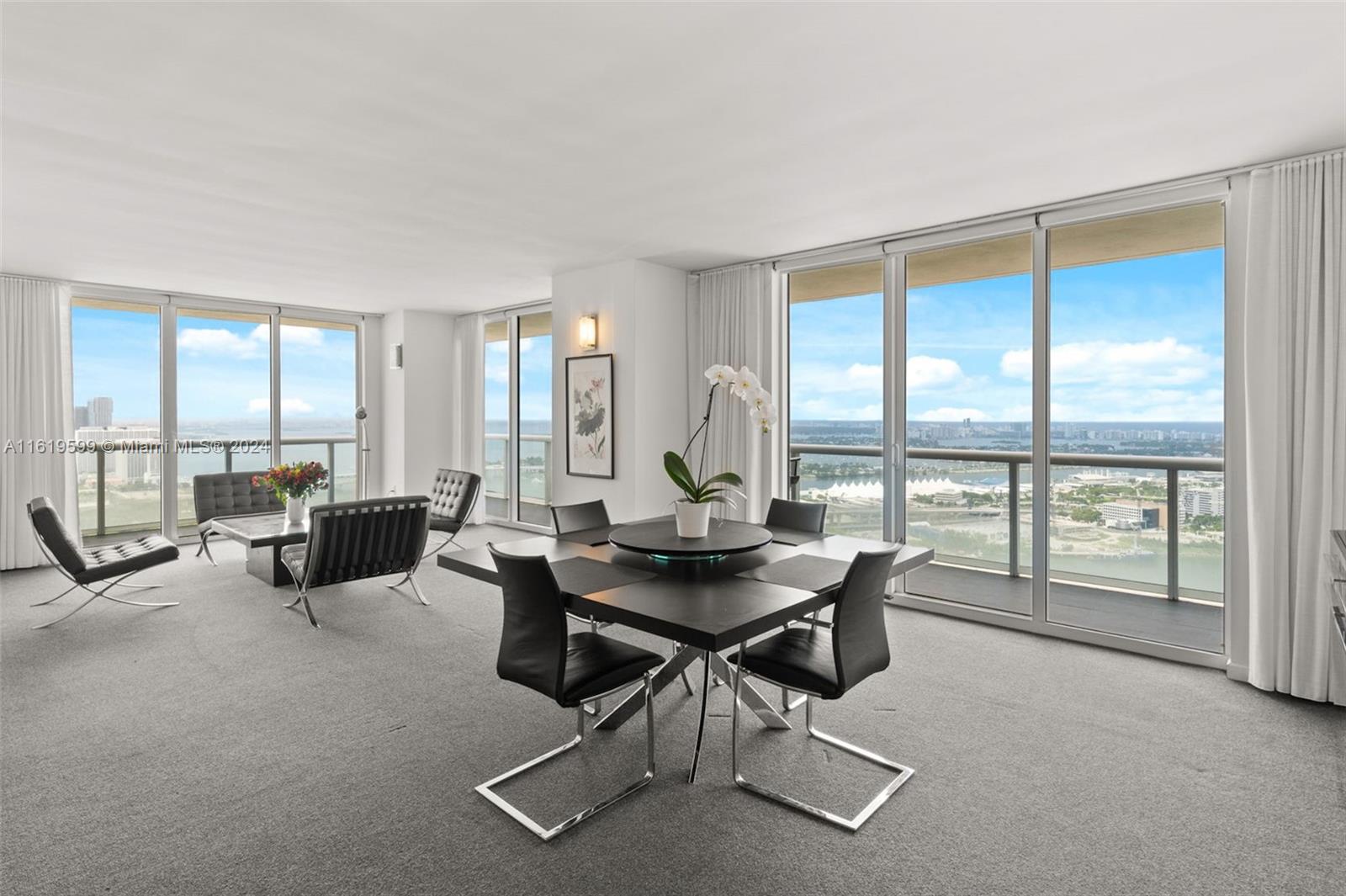 50 Biscayne Boulevard, Unit 4802 Miami, FL 33132 - Photo 3 of 27 a living room with furniture and large windows