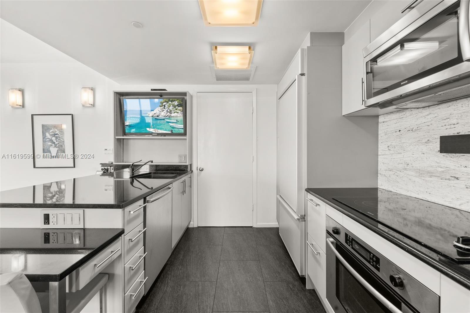 50 Biscayne Boulevard, Unit 4802 Miami, FL 33132 - Photo 5 of 27 a kitchen with stainless steel appliances granite countertop a stove and a refrigerator