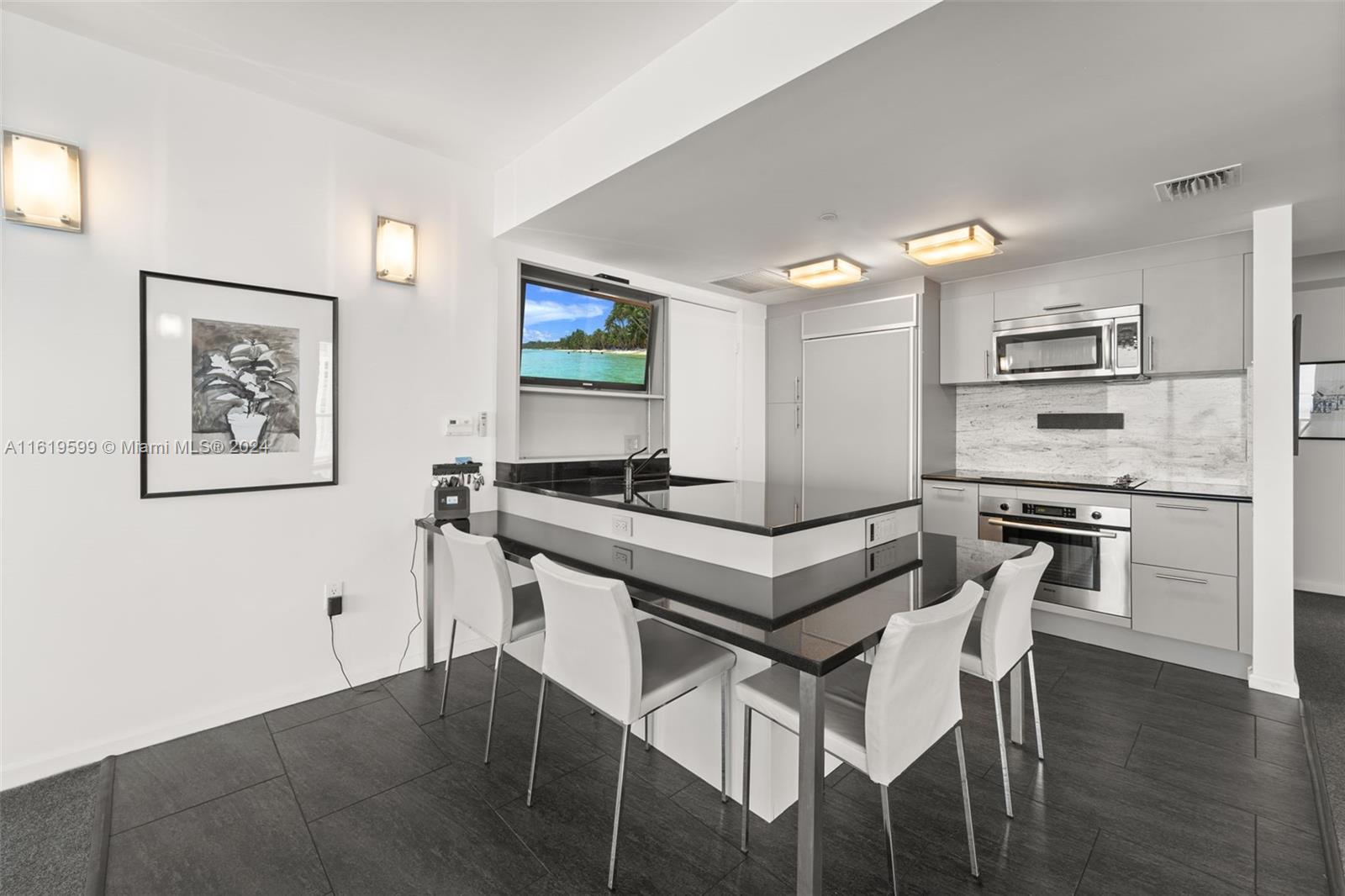 50 Biscayne Boulevard, Unit 4802 Miami, FL 33132 - Photo 6 of 27 a kitchen with a table and chairs