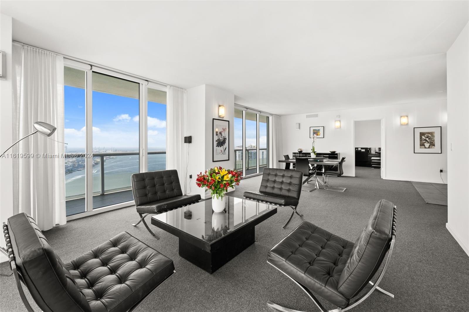 50 Biscayne Boulevard, Unit 4802 Miami, FL 33132 - Photo 8 of 27 a living room with furniture and a large window