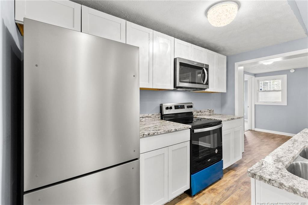 8424 King Road Fayetteville, NC 28306 - Photo 12 of 35 a kitchen with stainless steel appliances granite countertop a refrigerator sink and stove