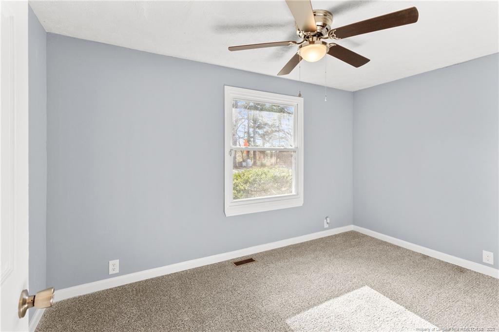 8424 King Road Fayetteville, NC 28306 - Photo 20 of 35 an empty room with a window and a fan