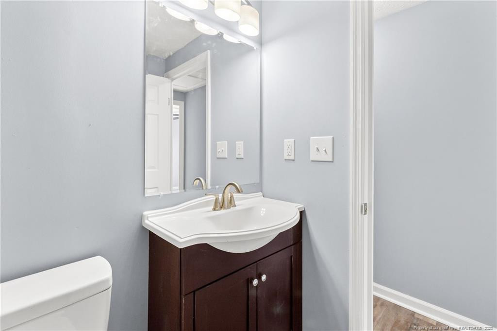8424 King Road Fayetteville, NC 28306 - Photo 23 of 35 a bathroom with a sink a toilet and mirror