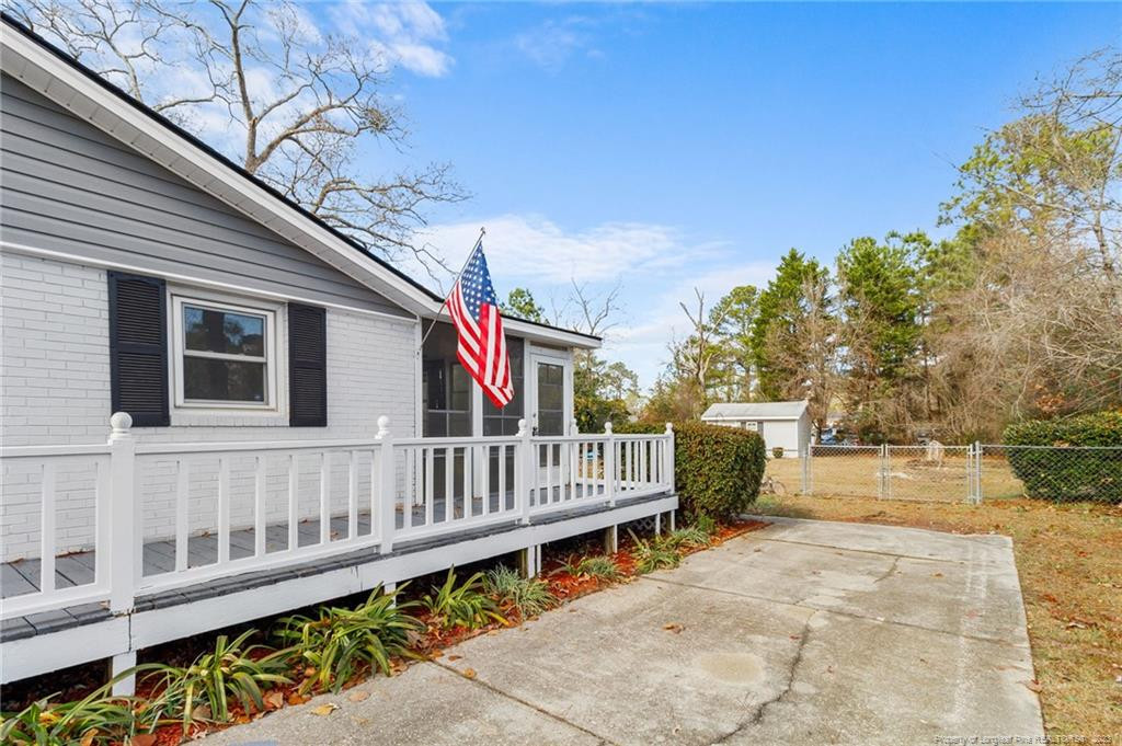 8424 King Road Fayetteville, NC 28306 - Photo 29 of 35 a view of a house with wooden deck and furniture