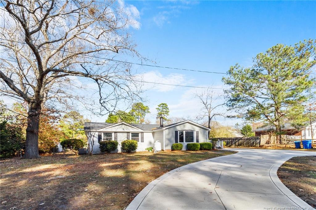 8424 King Road Fayetteville, NC 28306 - Photo 4 of 35 a view of a white house next to a road and yard