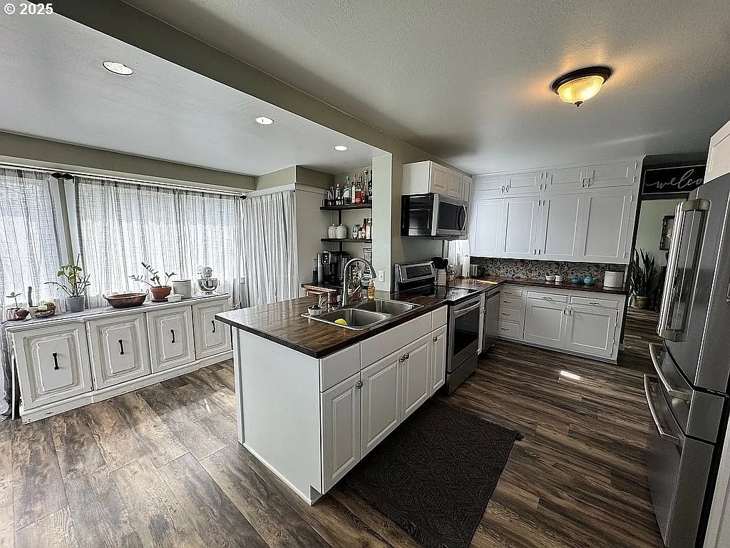 204 Northwest 6th Street Pendleton, OR 97801 - Photo 4 of 14 a kitchen with stainless steel appliances a sink stove and refrigerator