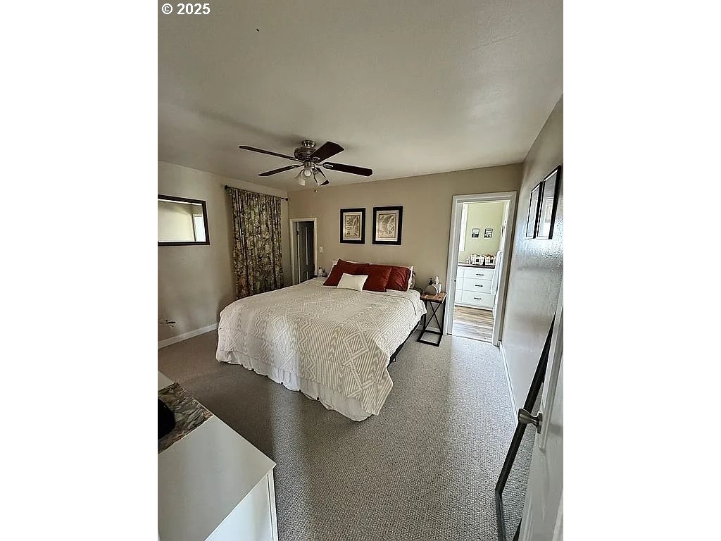 204 Northwest 6th Street Pendleton, OR 97801 - Photo 6 of 14 a bedroom with a bed and a night stand