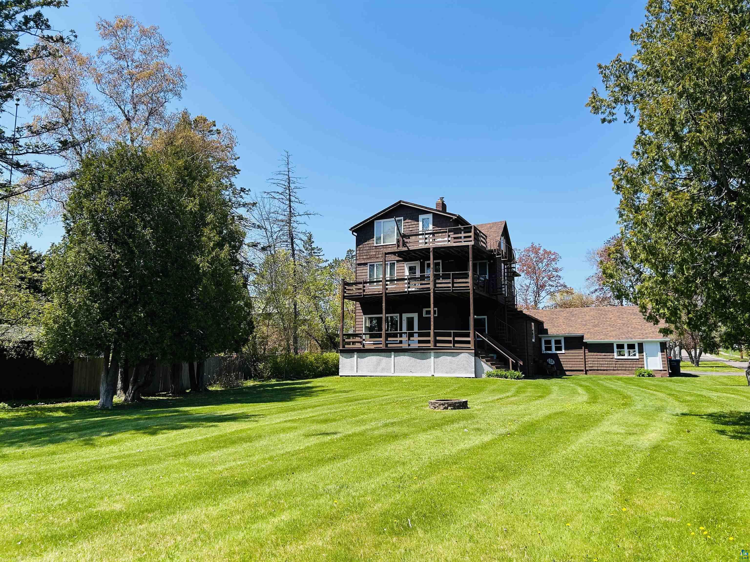 5090 London Road, Unit 1 Duluth, MN 55804 - Photo 53 of 54 Expansive green lawn with mature trees bordering the property