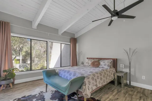 a bedroom with a large bed and a large window