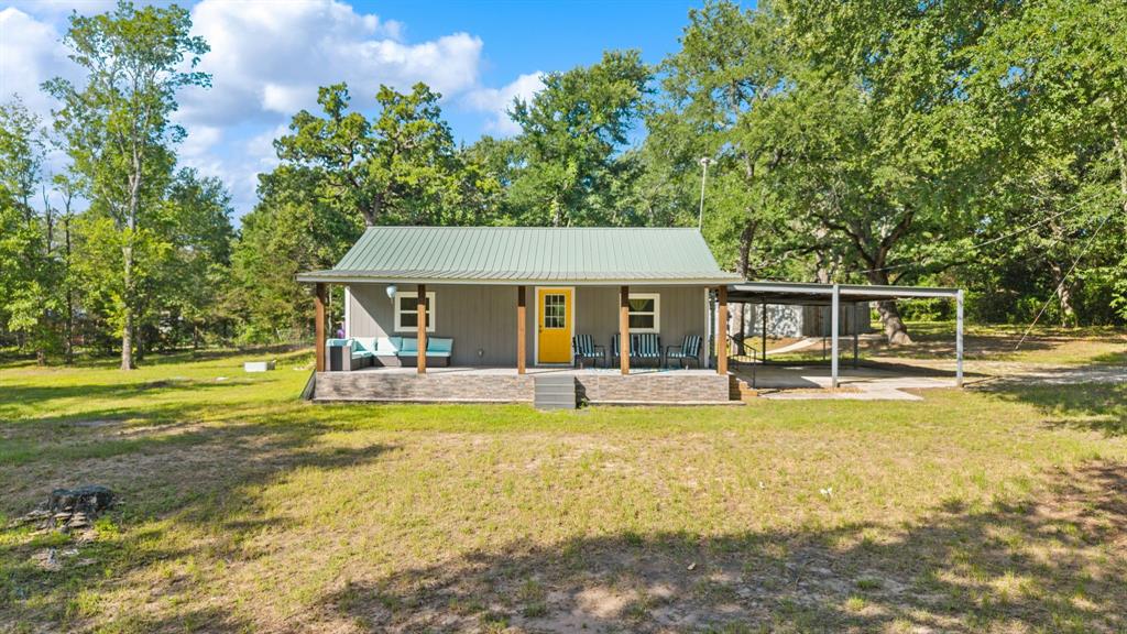 17790 County Road 345 Terrell, TX 75161 - Photo 2 of 37 a view of a swimming pool with table and chairs under an umbrella