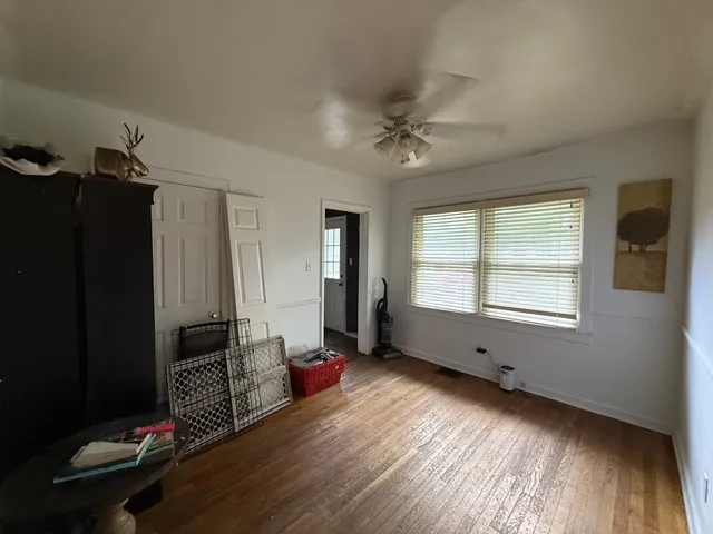 a living room with furniture window and wooden floor