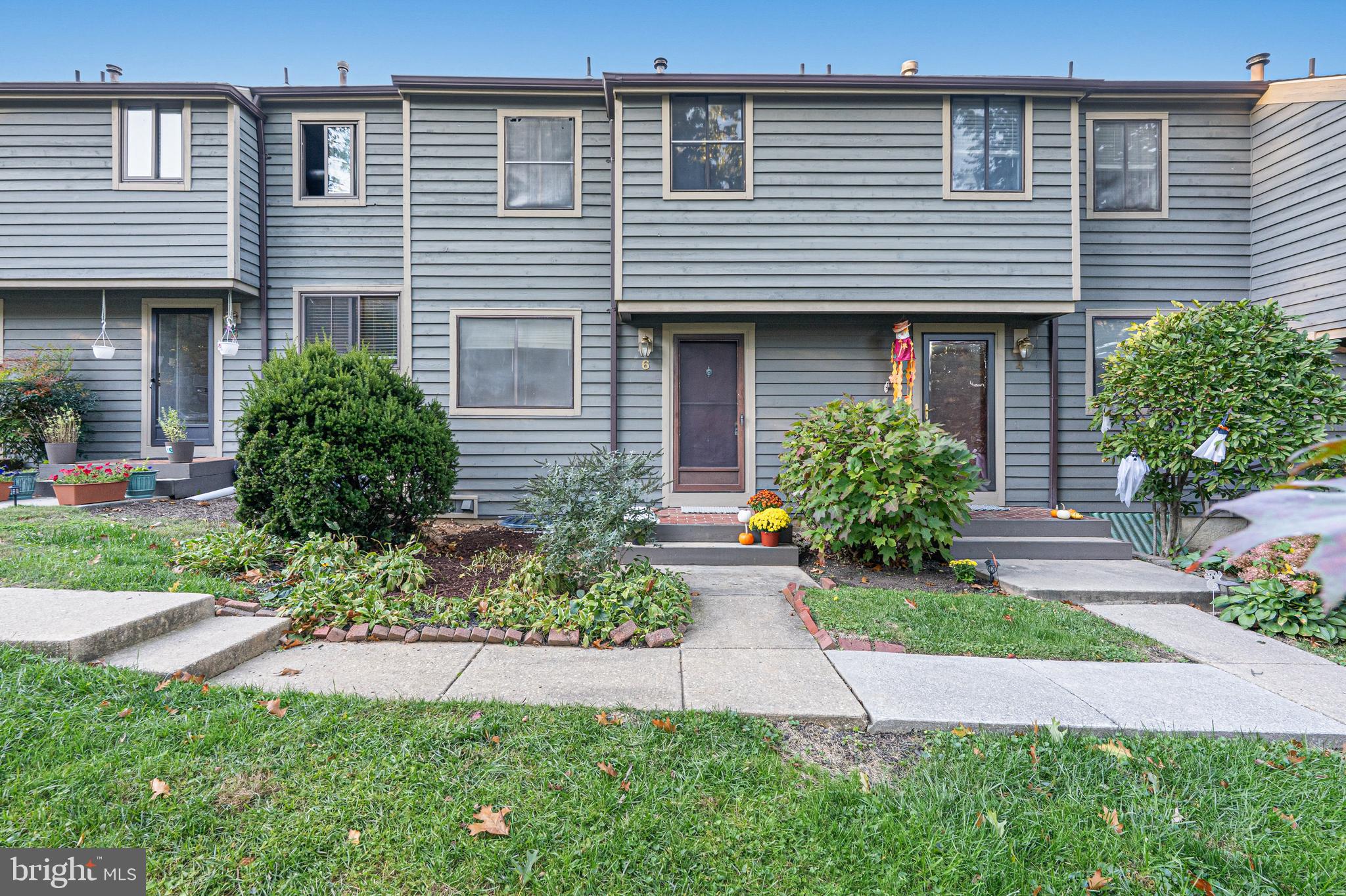 6 Stone Ridge Court, Unit 29 Baltimore, MD 21239 - Photo 1 of 26 a front view of a house with a yard and outdoor seating