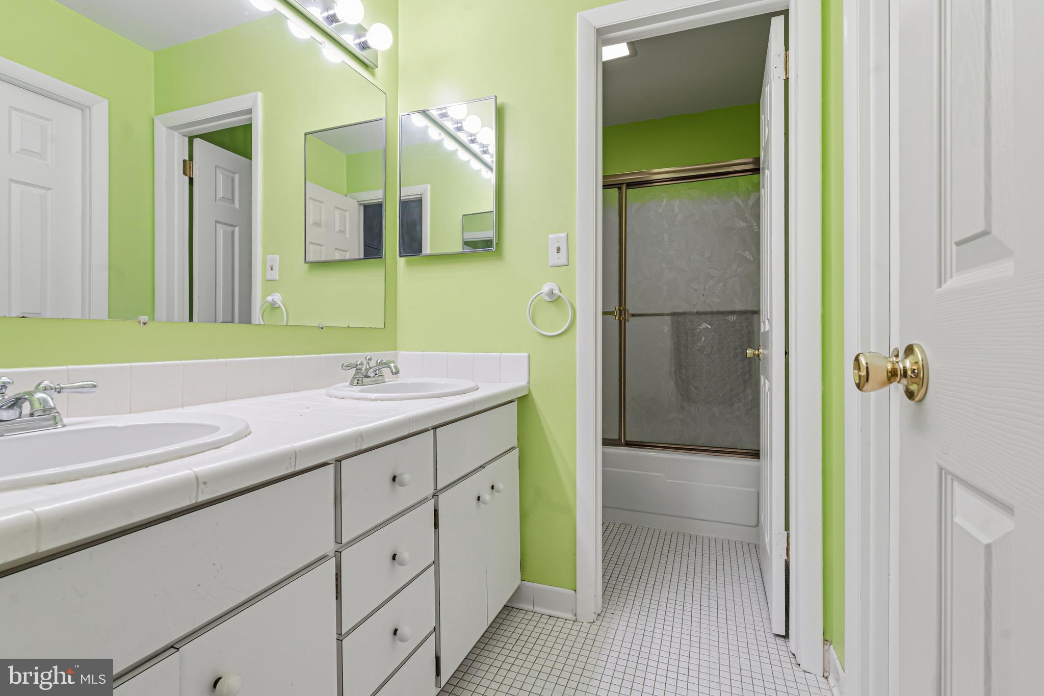 6 Stone Ridge Court, Unit 29 Baltimore, MD 21239 - Photo 14 of 26 a bathroom with a double vanity sink and mirror