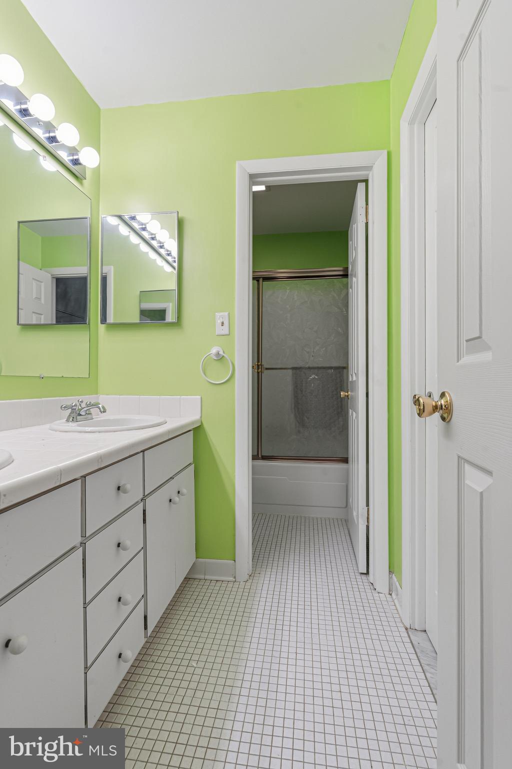 6 Stone Ridge Court, Unit 29 Baltimore, MD 21239 - Photo 15 of 26 a spacious bathroom with a sink a mirror and a shower