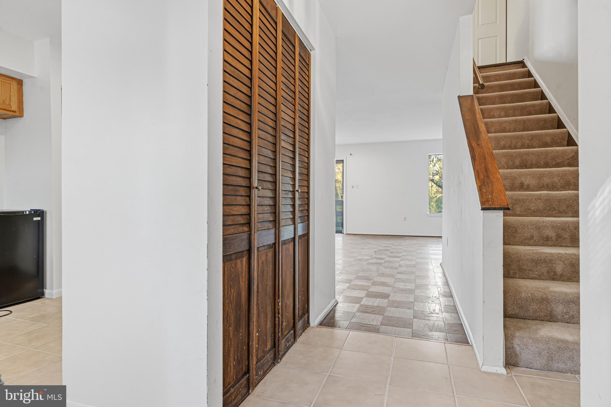 6 Stone Ridge Court, Unit 29 Baltimore, MD 21239 - Photo 4 of 26 a view of a hallway with paintings on the wall