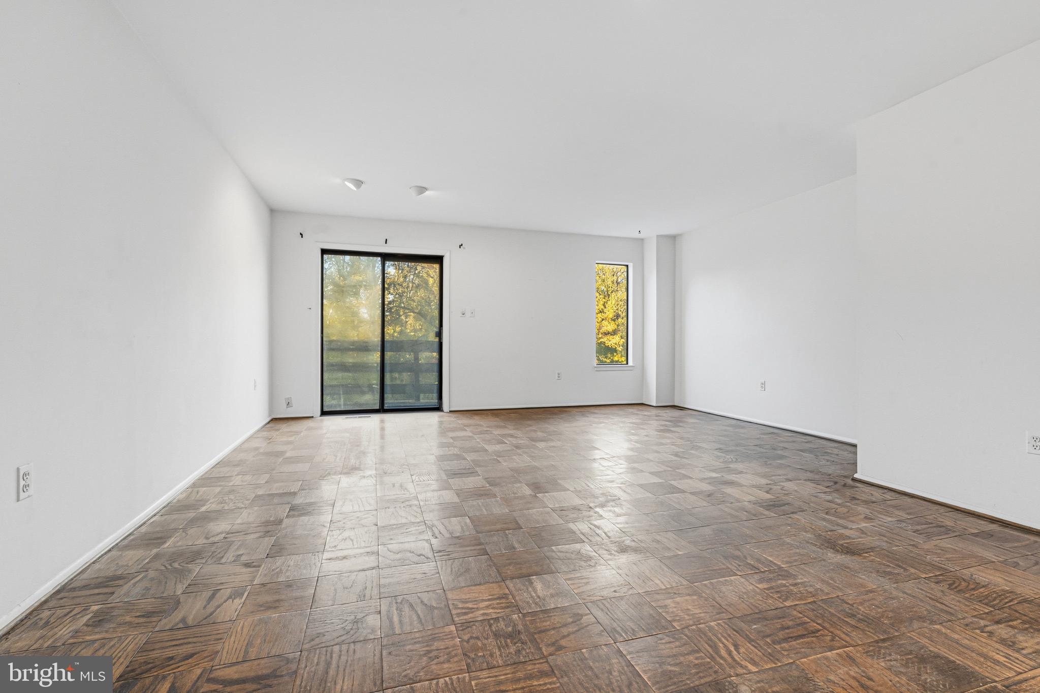 6 Stone Ridge Court, Unit 29 Baltimore, MD 21239 - Photo 9 of 26 an empty room with windows