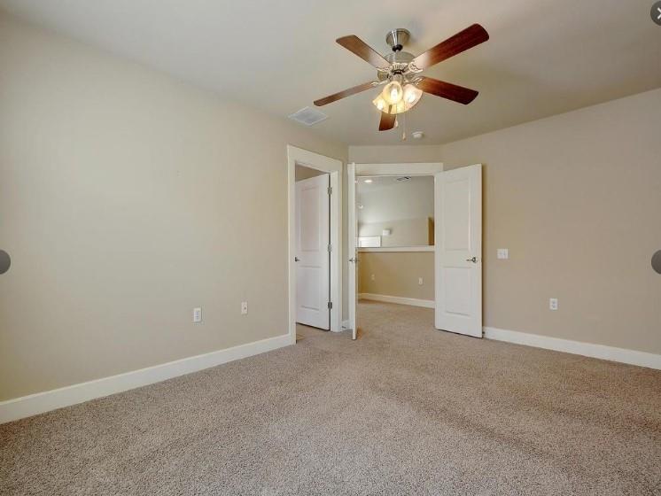 1601 Miriam Avenue, Unit 203 Austin, TX 78702 - Photo 22 of 29 an empty room with closet and a ceiling fan