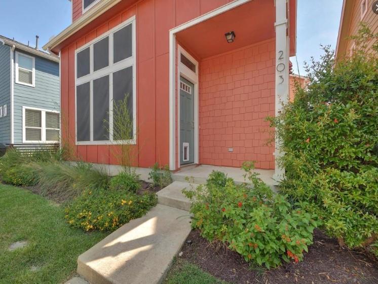 1601 Miriam Avenue, Unit 203 Austin, TX 78702 - Photo 3 of 29 a front view of a house with a yard