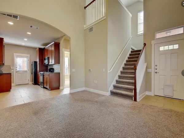 a view of a kitchen with furniture and stairs