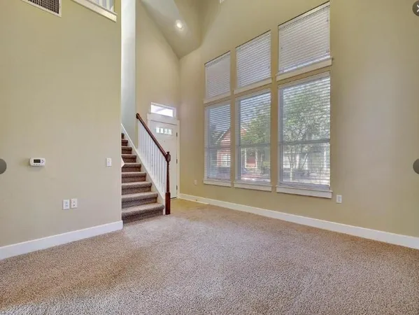 a view of room with stairs and windows