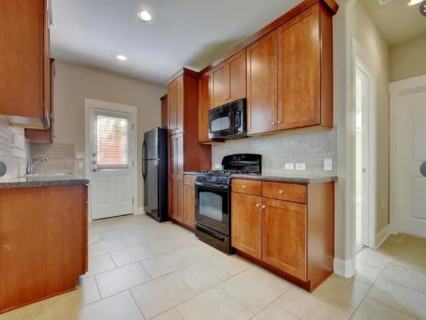 a kitchen with stainless steel appliances granite countertop a sink and cabinets