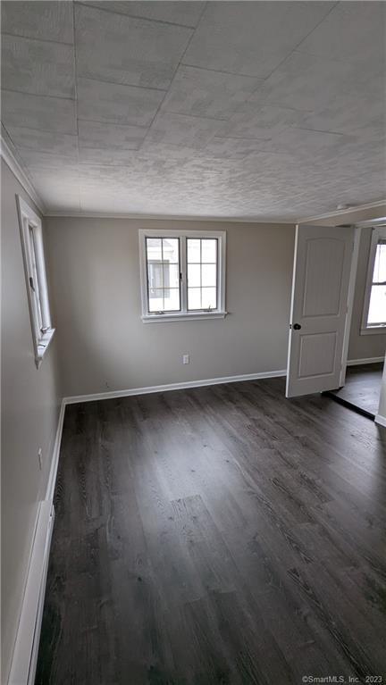 134 Bristol Street, Unit 2 Southington, CT 06489 - Photo 4 of 12 an empty room with wooden floor and windows