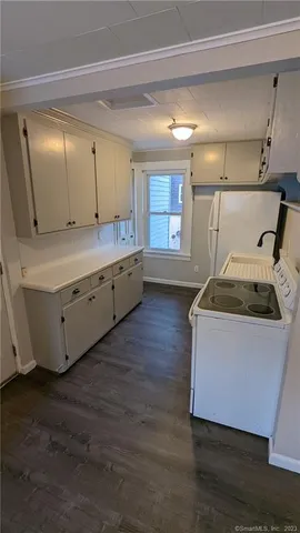 a room with wooden floor and sink