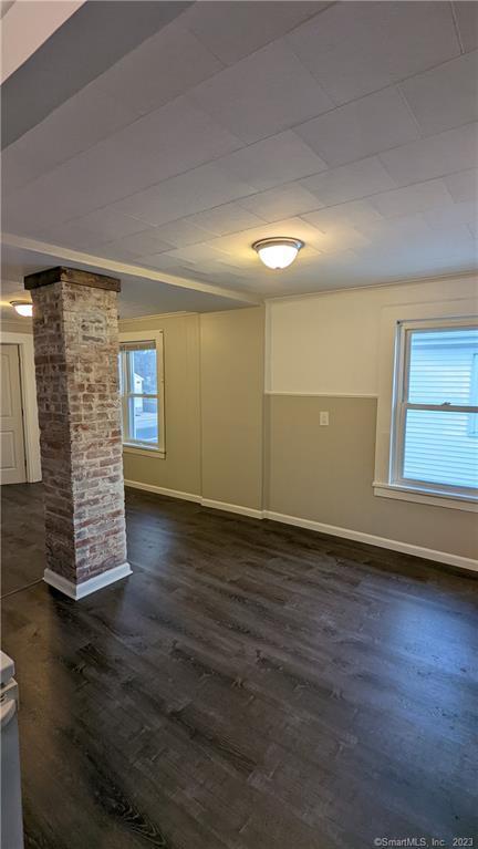 134 Bristol Street, Unit 2 Southington, CT 06489 - Photo 8 of 12 an empty room with wooden floor and windows