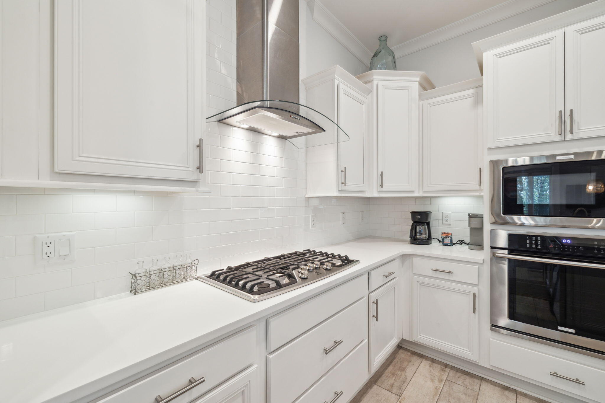309 Milestone Dr Inlet Beach, Unit A Inlet Beach, FL 32461 - Photo 13 of 54 a kitchen with granite countertop a stove a sink and dishwasher with white cabinets