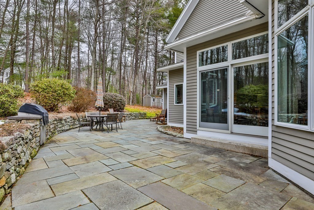 68 Slough Road Harvard, MA 01451 - Photo 35 of 35 a view of a patio with table and chairs and potted plants