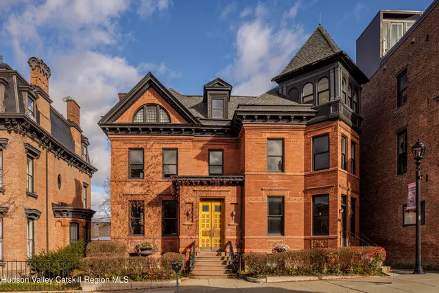 a front view of a residential apartment building with a street