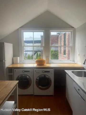 a kitchen with a sink cabinets and wooden floor