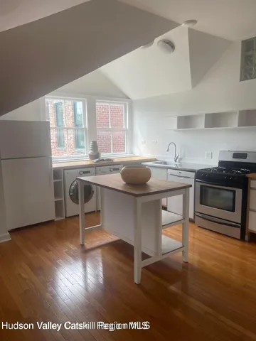 a view of kitchen with stainless steel appliances granite countertop a sink and a stove