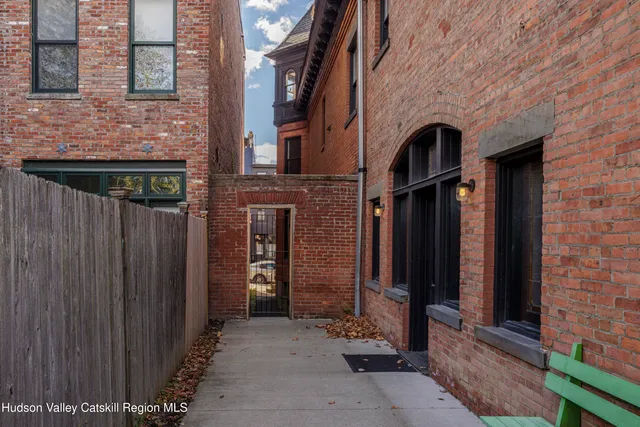 a couple of table and chairs in front of door