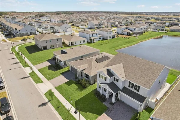 an aerial view of multiple houses with a yard